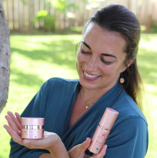 Woman Holding Honey Girl Organics Rose Products